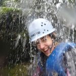 Gorge Walking Wales - Photograph of Girl under waterfall
